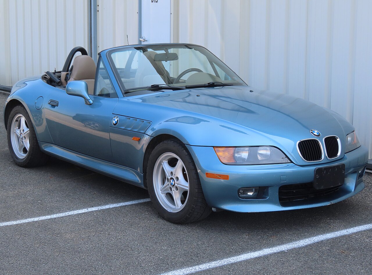 Light blue 1999 BMW Z3 roadster with its roof down, front right three-quarter view in a car park.