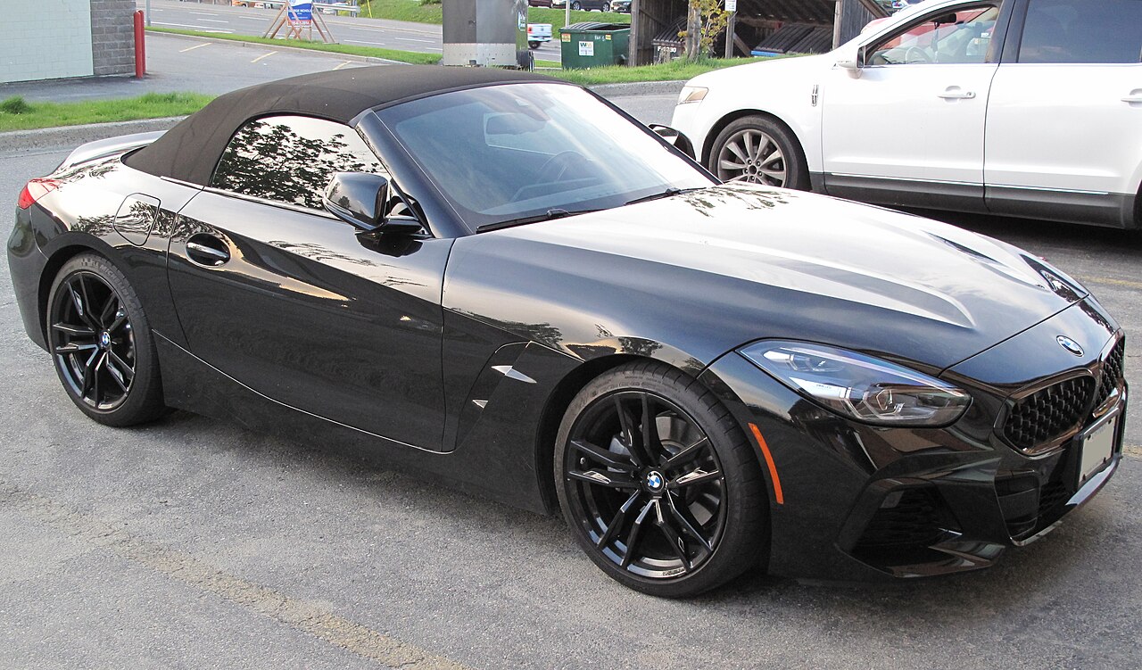 Black 2020 BMW Z4 sDrive30i with its soft top up and black alloy wheels, front right three-quarter view in a car park.