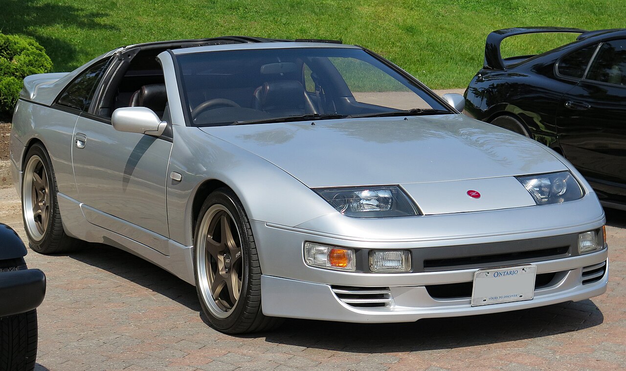 Silver 1991 Nissan Fairlady Z 300ZX Twin Turbo with its T-top panels removed, front right three-quarter view on brick paving.