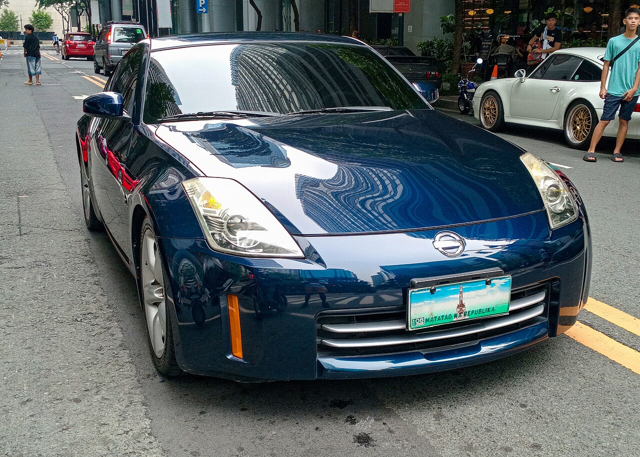 Dark blue 2007 Nissan 350Z coupe, front right three-quarter view on a busy city street.