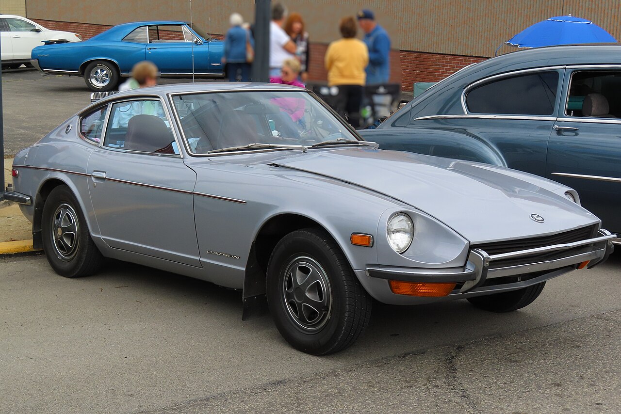 Silver 1972 Datsun 240Z, front right three-quarter view parked on a street at a car cruise.