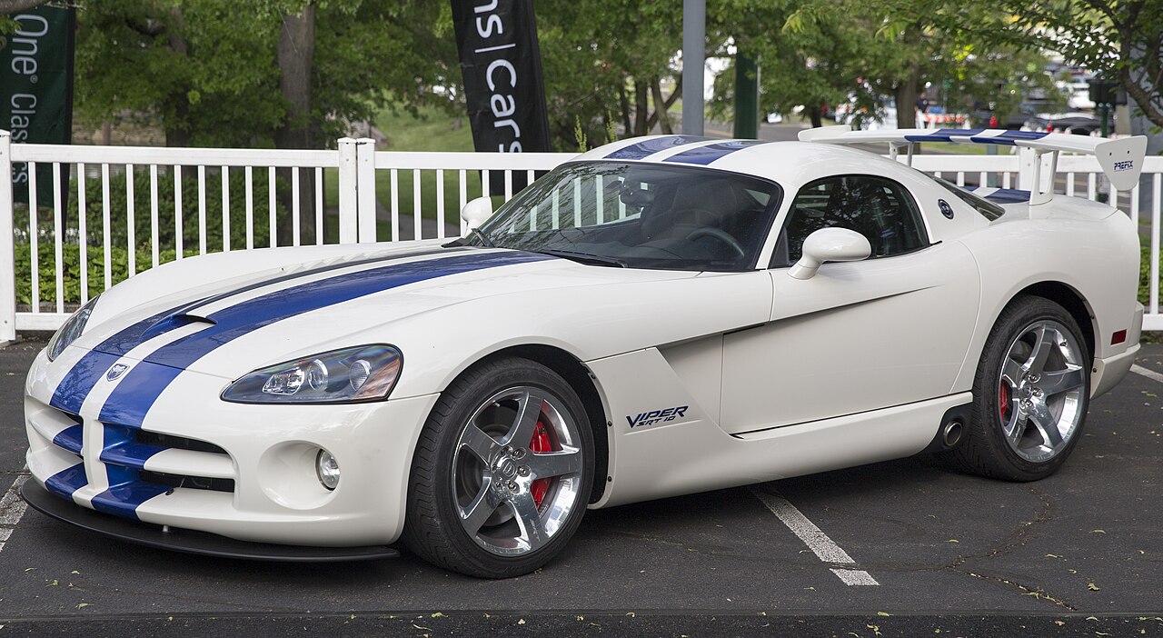 2006 Dodge Viper SRT-10 special edition in white with blue stripes and a large rear wing, front left view in a car park.