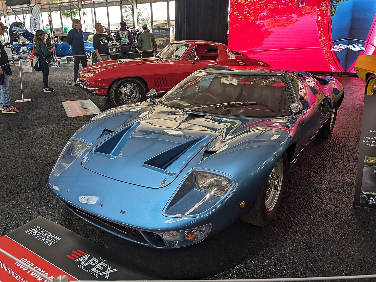 Metallic blue 1966 Ford GT40 Mk I road car with wire wheels, front three-quarter view at a car auction.