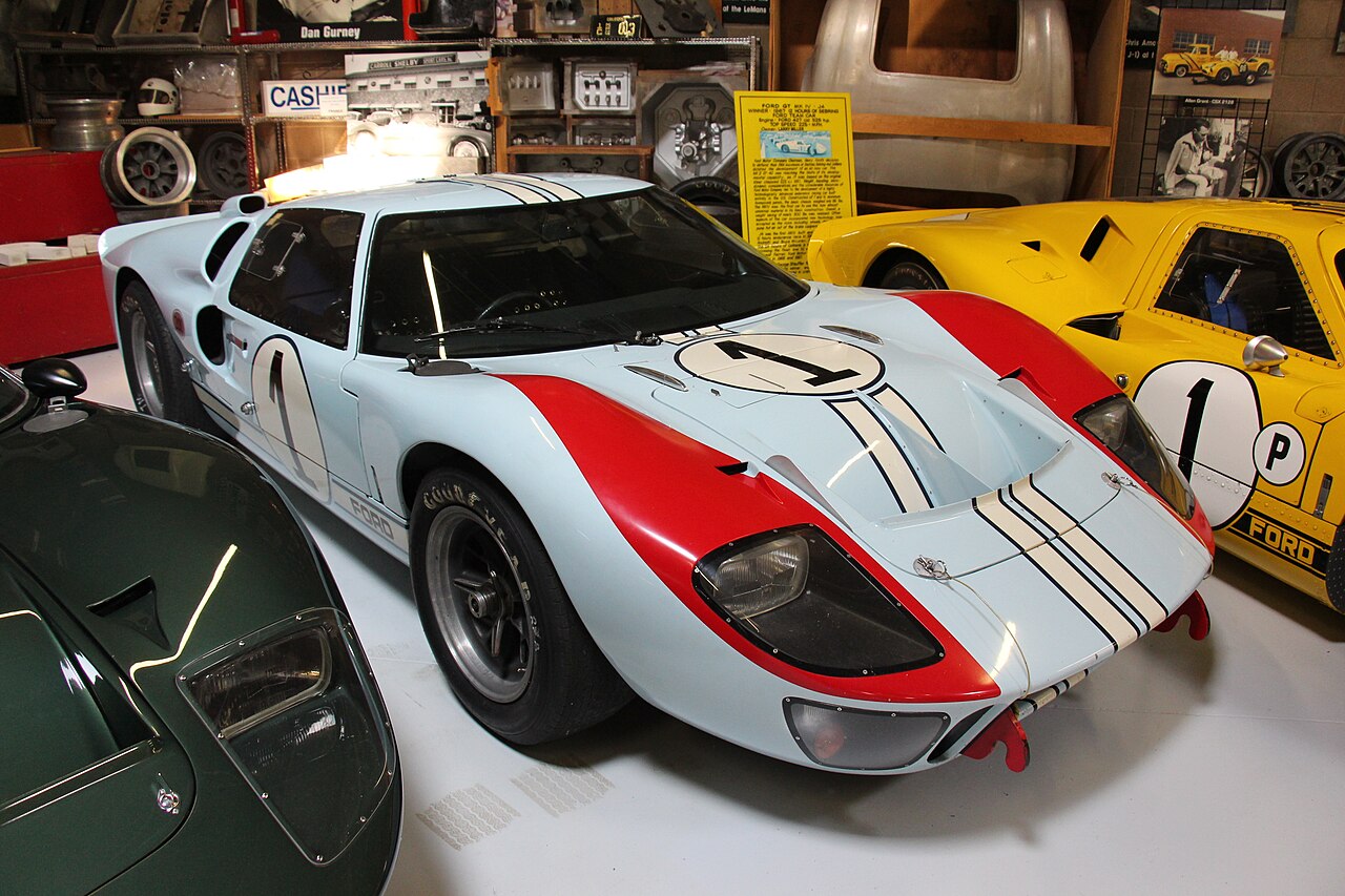 Light blue Ford GT40 Mk II in its 1966 Le Mans race livery with red front fenders and the number 1, seen in a museum.