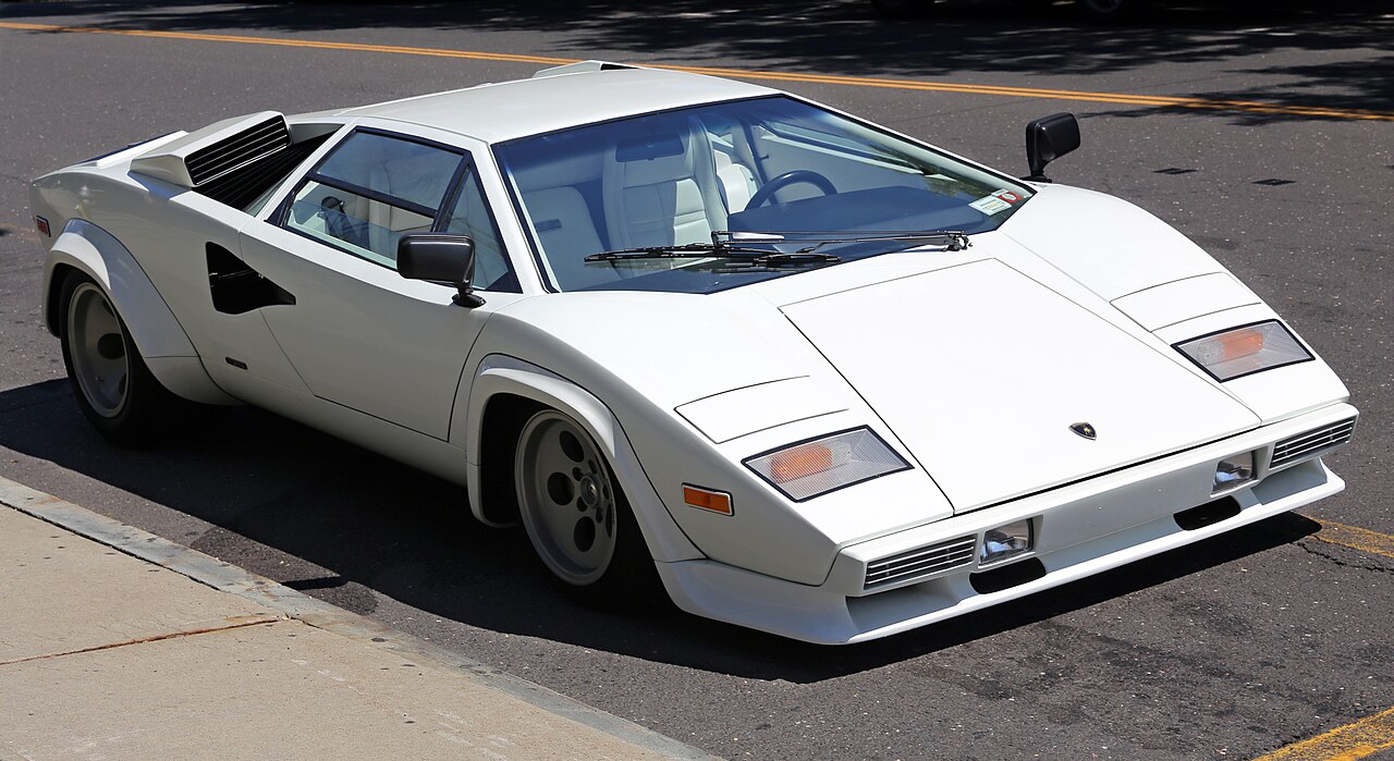 White 1981 Lamborghini Countach LP400S, front three-quarter view parked on a street.