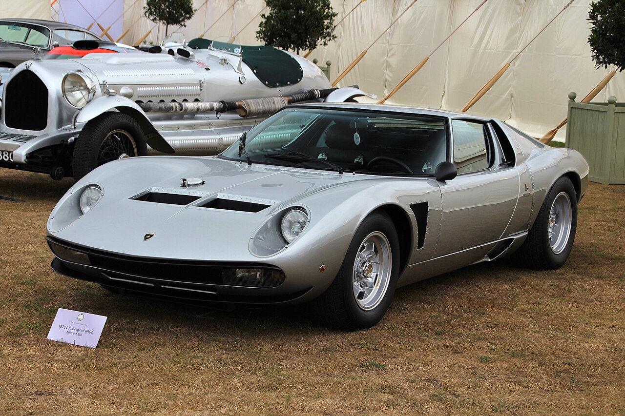 Silver 1973 Lamborghini Miura SV/J, front three-quarter view on grass in a show marquee.