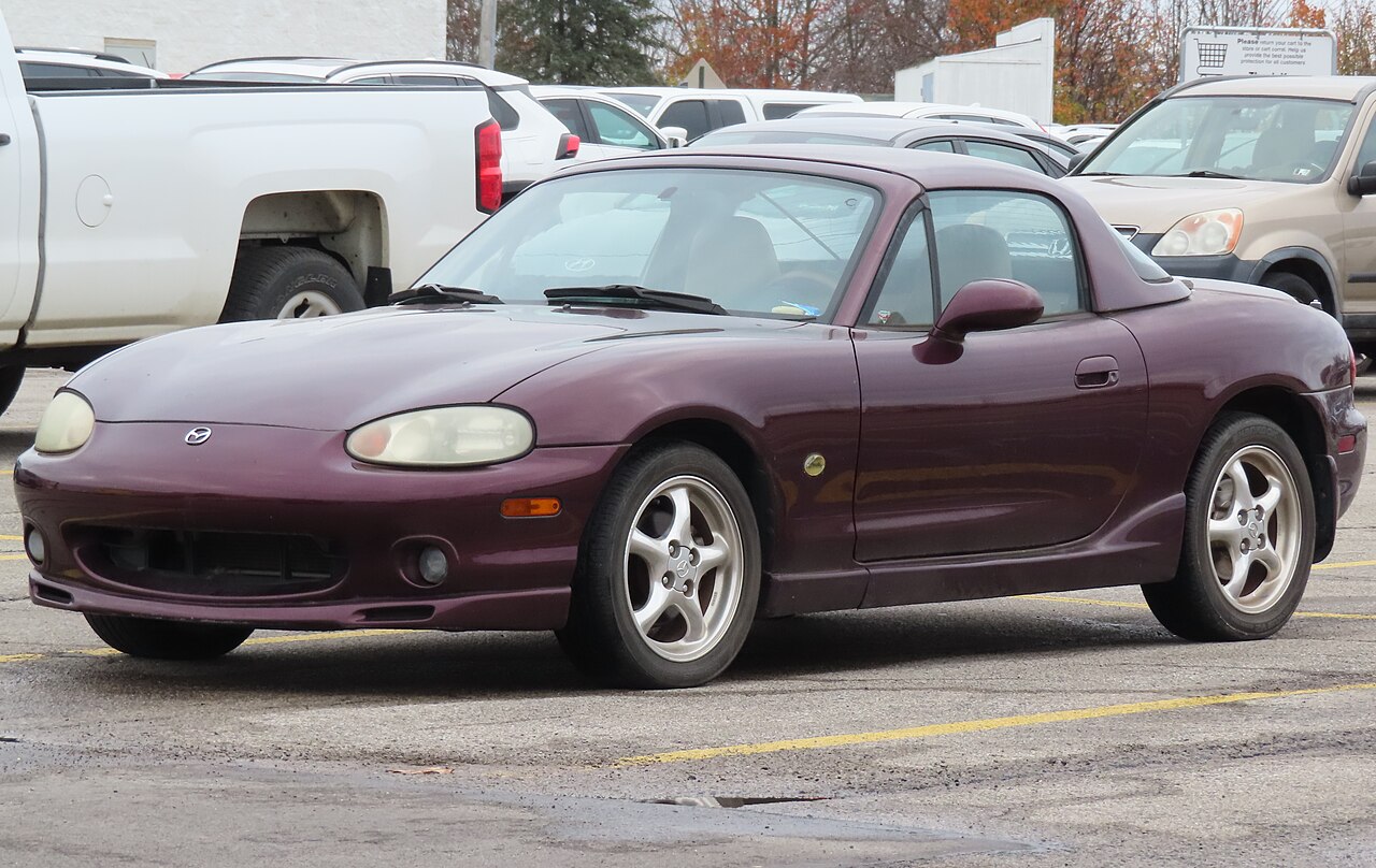 2000 Mazda Miata Special Edition in burgundy with its hardtop on, front three-quarter view in a car park.