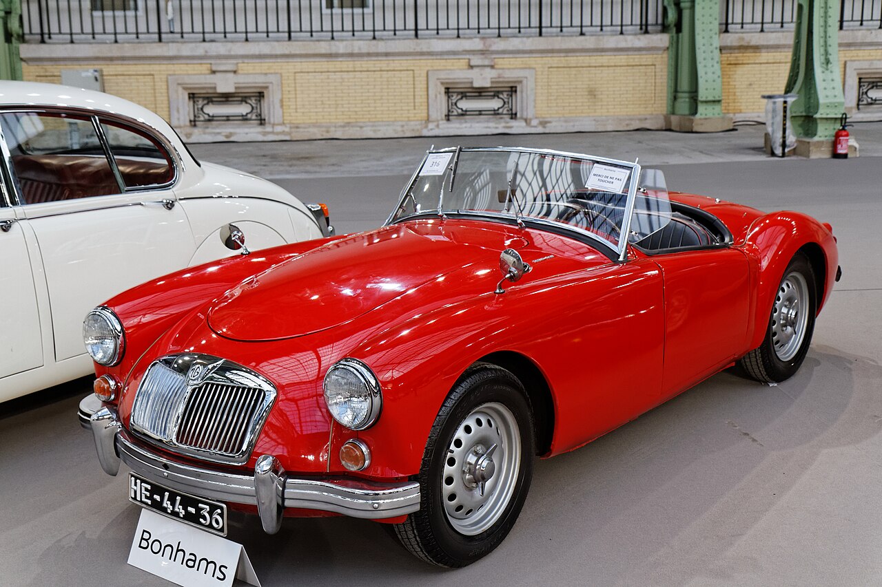 Red 1959 MGA Twin Cam roadster with its roof down, front three-quarter view at a Paris auction preview.