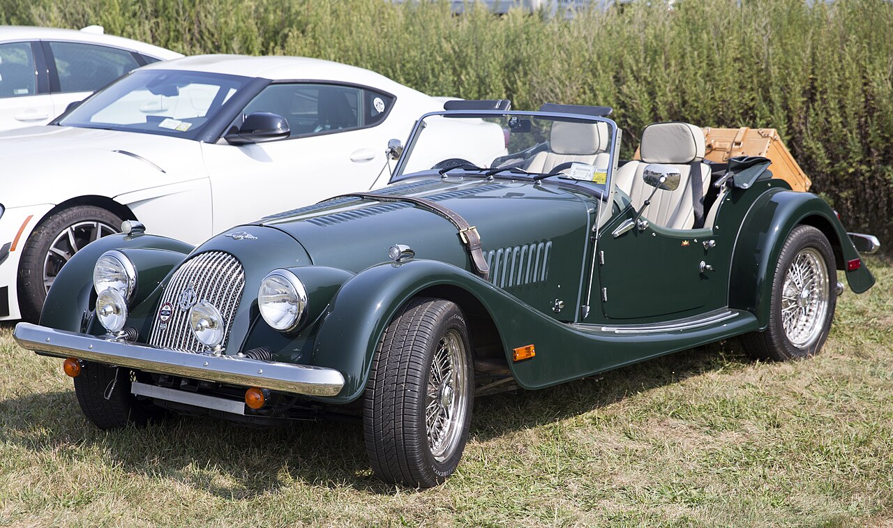 2003 Morgan Plus 8 35th Anniversary in dark green with its roof down, front left three-quarter view on grass.