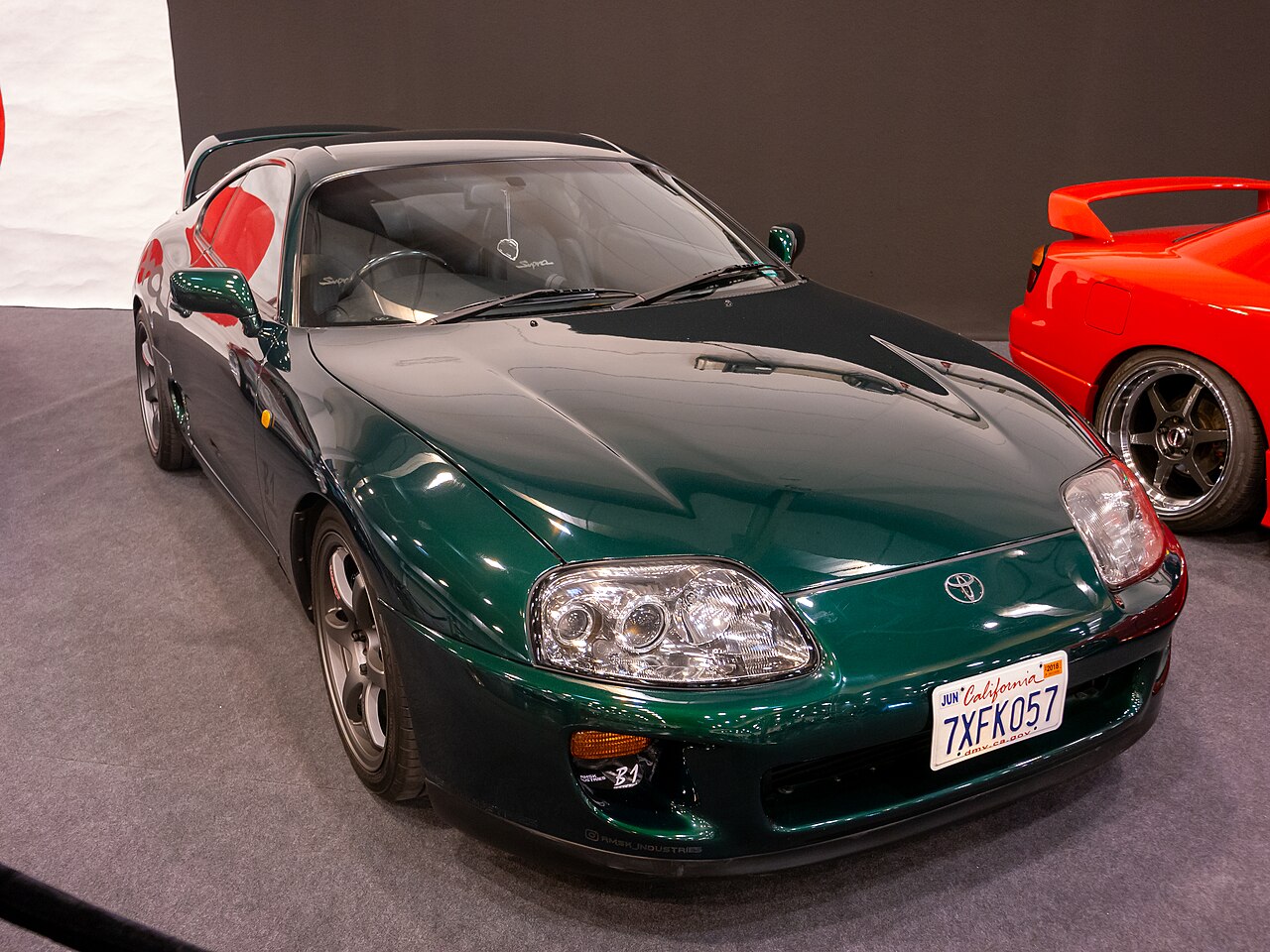 Dark green Toyota Supra A80, front right three-quarter view indoors at the 2023 Essen Motor Show.