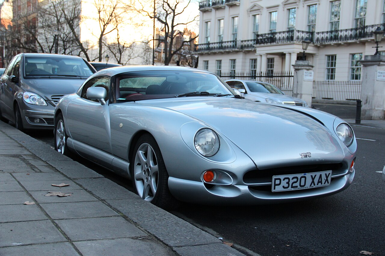 Silver TVR Cerbera coupe parked at the kerb on a city street, front right three-quarter view.