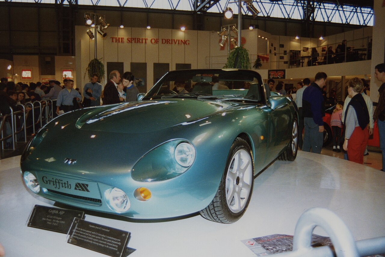 Green TVR Griffith with its roof down on a display stand at the 1992 NEC Birmingham car show, front three-quarter view.