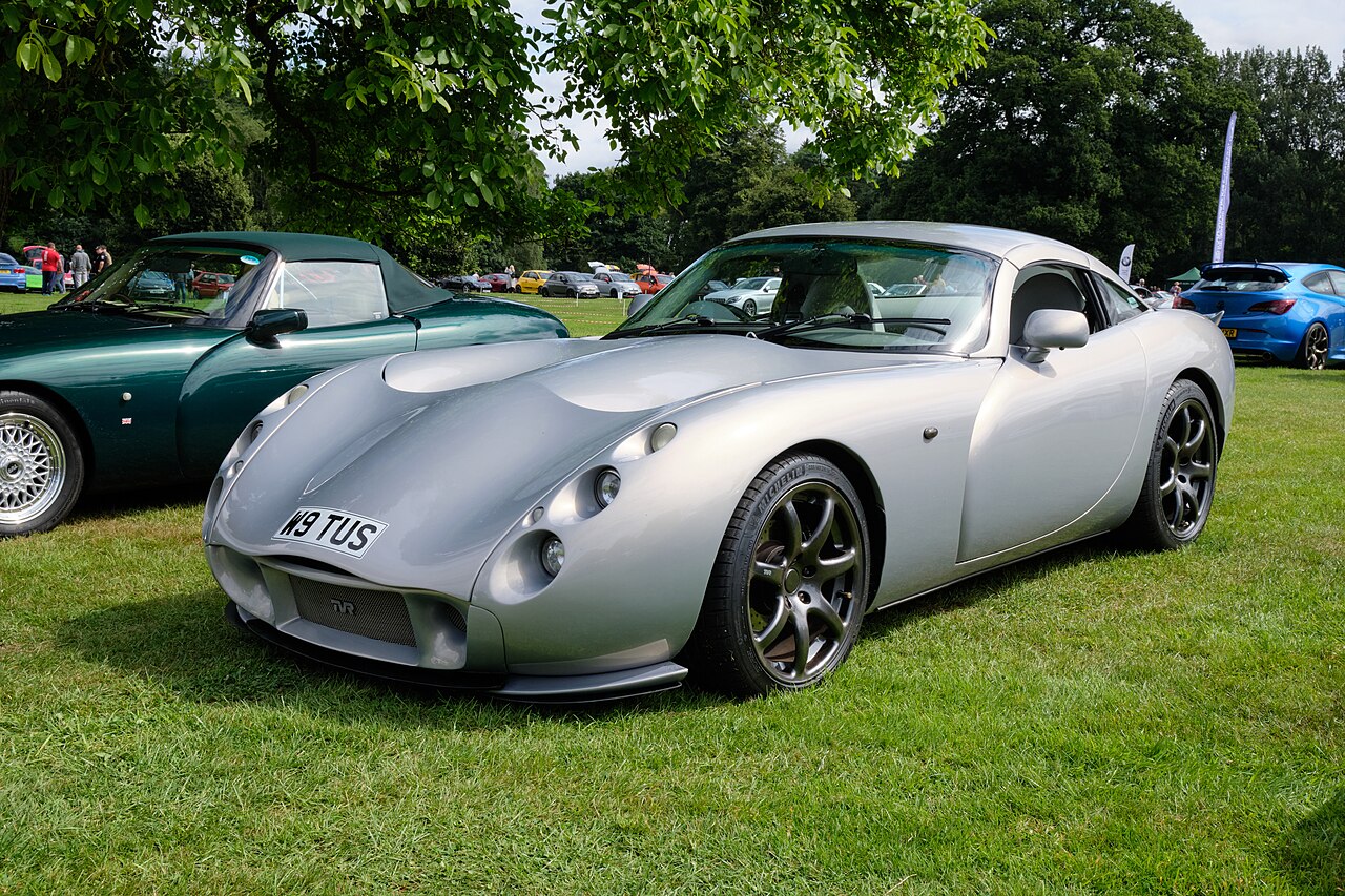 Silver TVR Tuscan coupe, front left three-quarter view on grass at an outdoor car show.